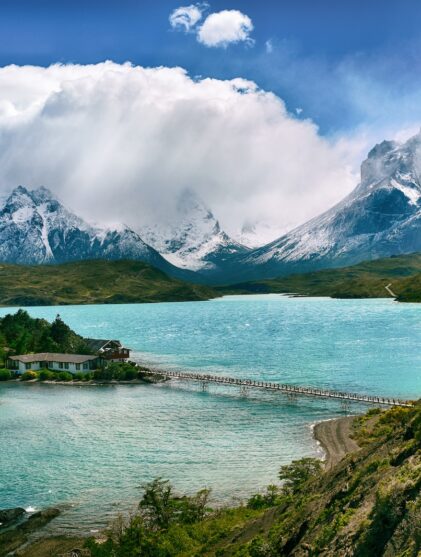 lake near snow-covered mountain during daytime